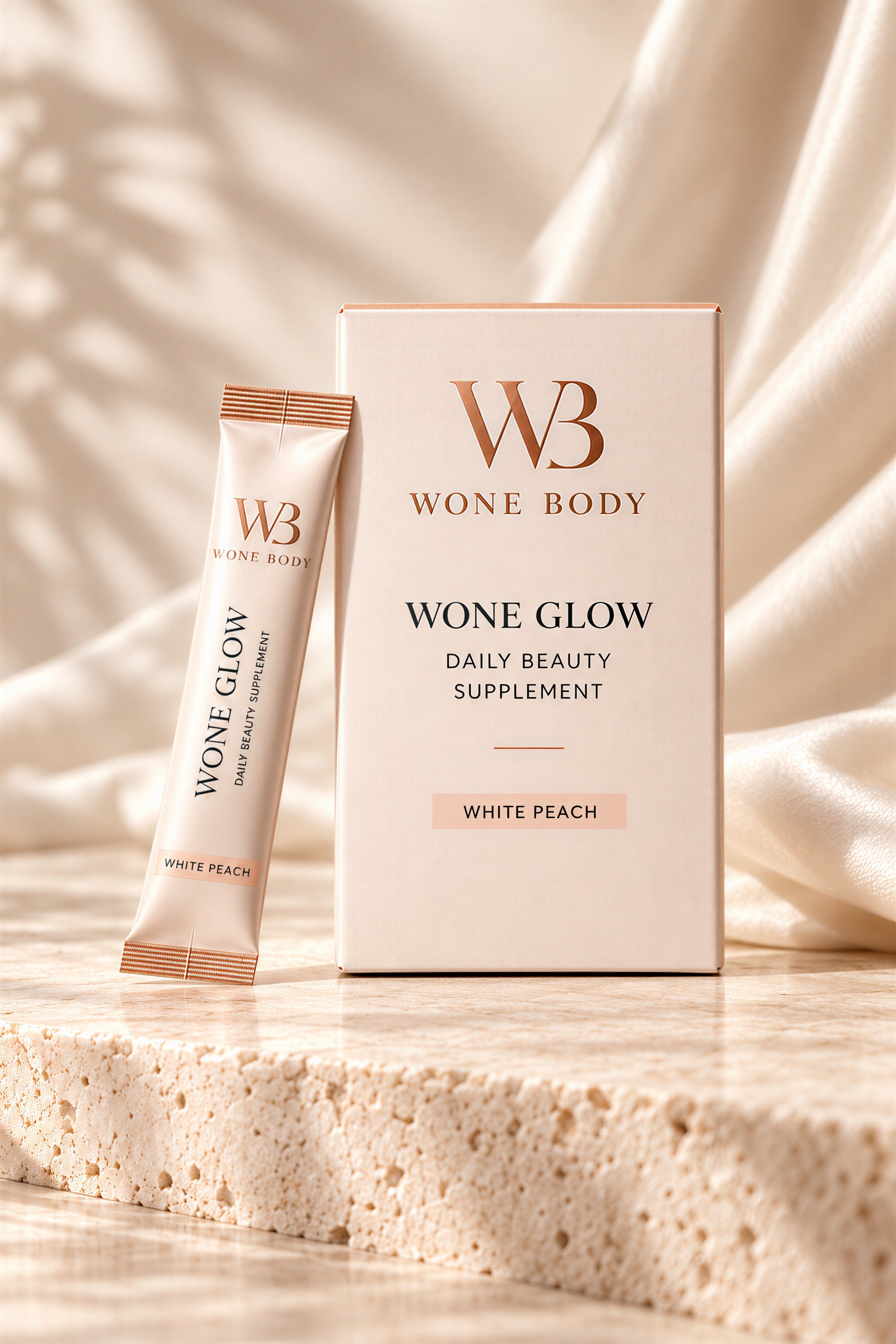 Wone Glow product concept: a White Peach beauty supplement carton and stick pack on pale stone